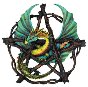 Colorful dragon sculpture on a pentagram design with branches.
